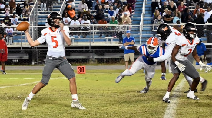 Lake Wales quarterback Brycen Levidiotis unleashes a pass against Bartow. The Highlanders won 28-3 for their 25th consecutive win.